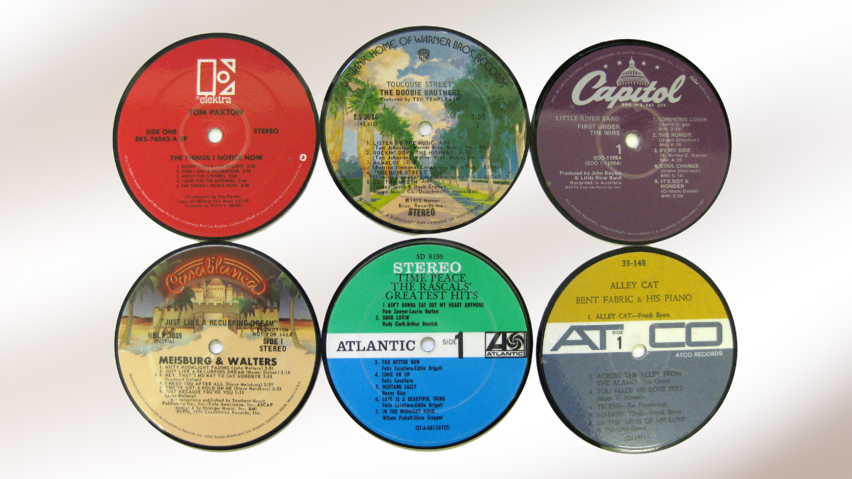 A collection of six vintage vinyl record labels from various music labels, including Capitol, Atlantic, and Warner Bros., arranged in two rows on a white background.